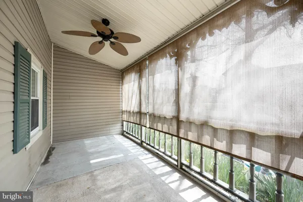 a view of a porch with wooden floor