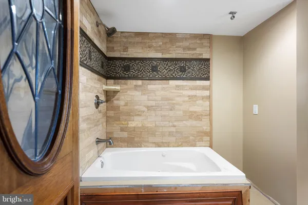 a bathroom with a bathtub and a shower