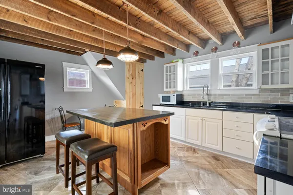 a kitchen with stainless steel appliances granite countertop a stove a sink dishwasher and cabinets with wooden floor