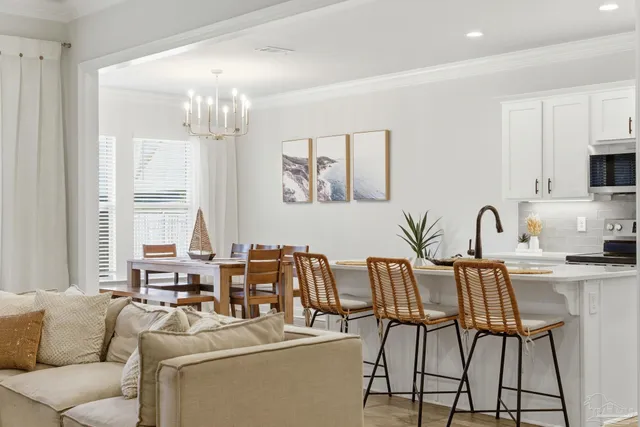 a living room with furniture and a chandelier
