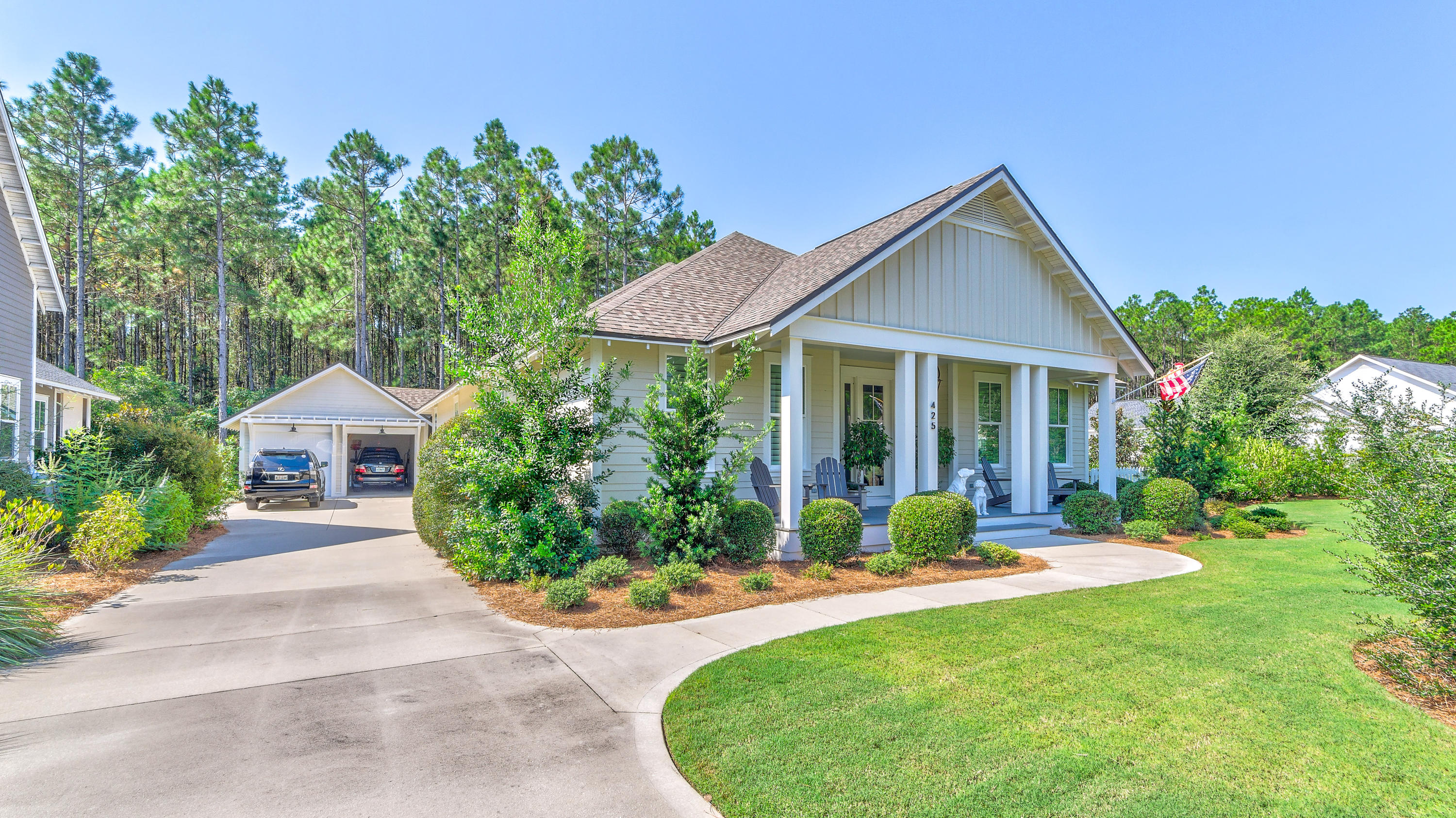 425 Medley Street Watersound, FL 32461 - Photo 3 of 29 a view of a house with a yard and potted plants