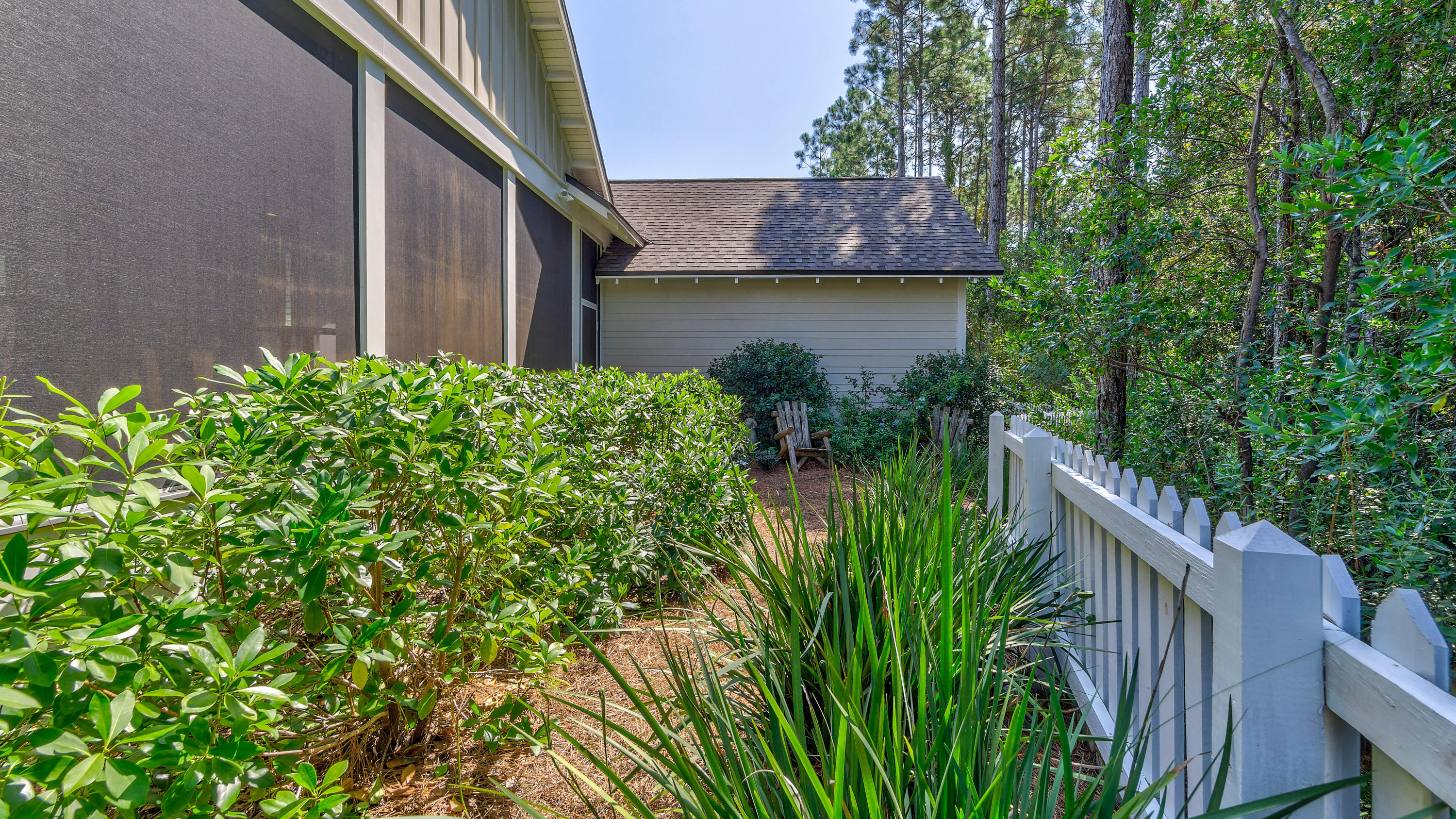 425 Medley Street Watersound, FL 32461 - Photo 26 of 29 a backyard with potted plants and a large tree