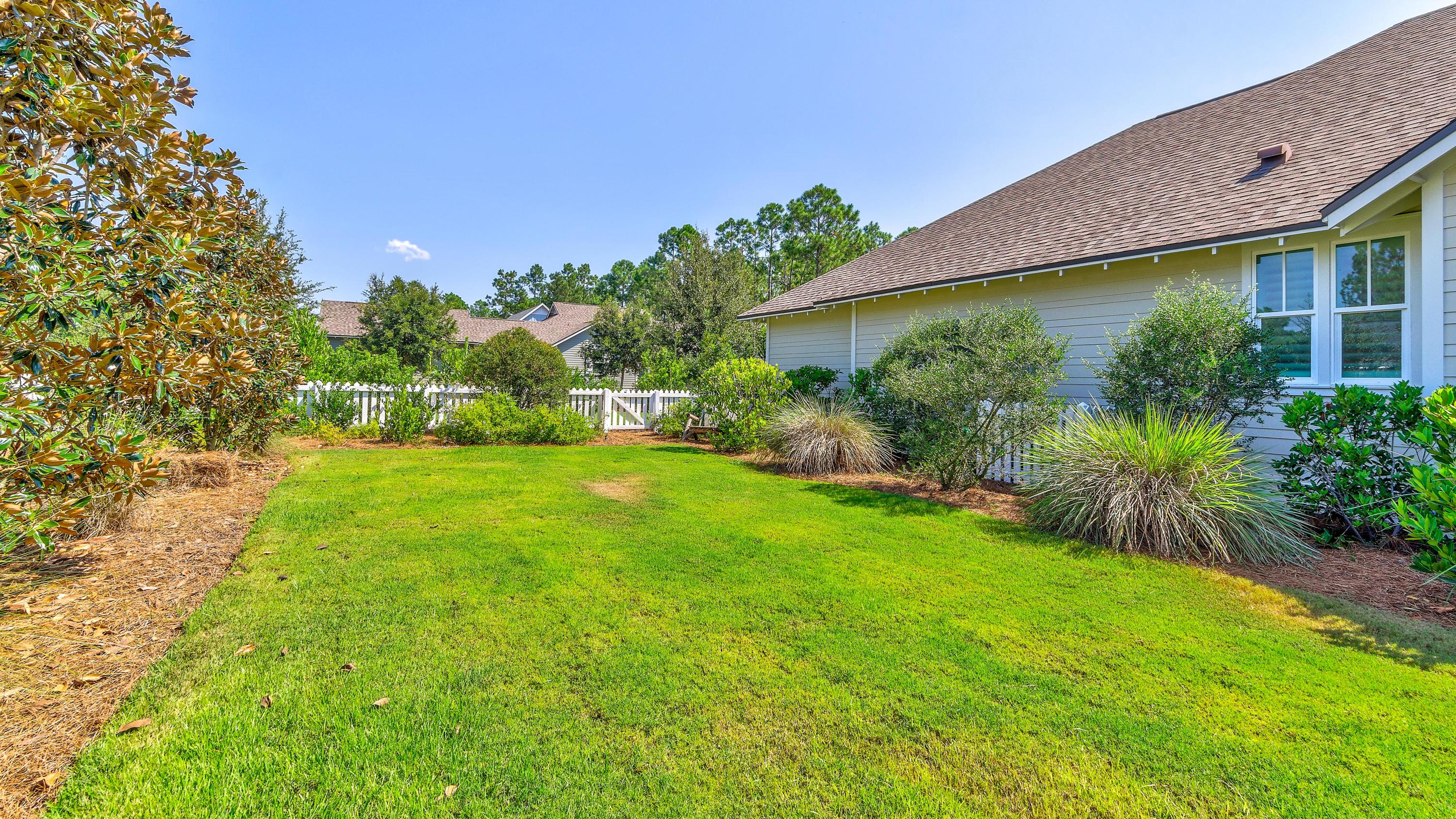 425 Medley Street Watersound, FL 32461 - Photo 27 of 29 a view of a backyard with plants and a patio