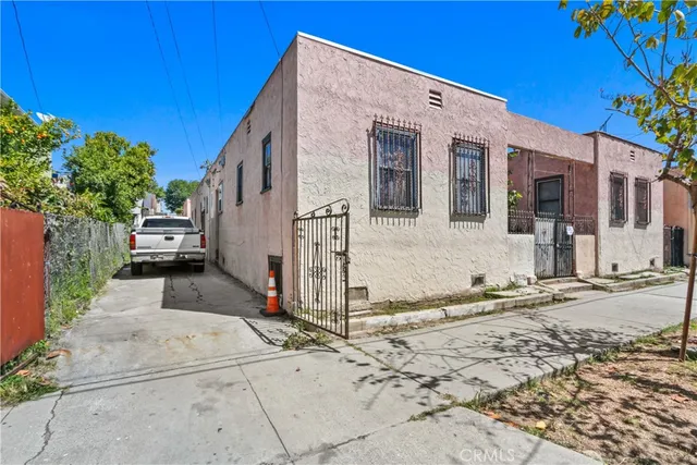 a view of a white house with a yard