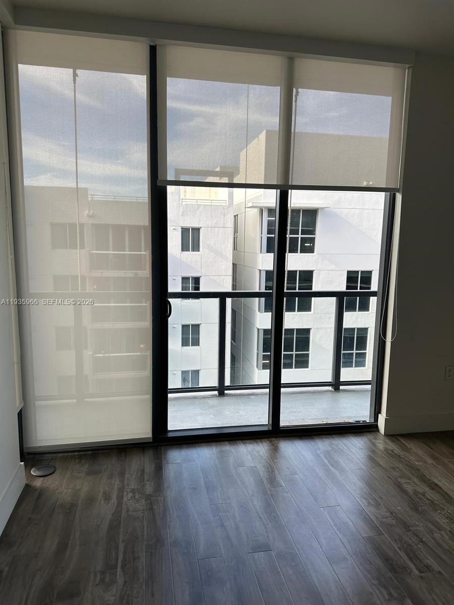 201 Southwest 17th Road, Unit 803 Miami, FL 33129 - Photo 17 of 22 an empty room with wooden floor and windows