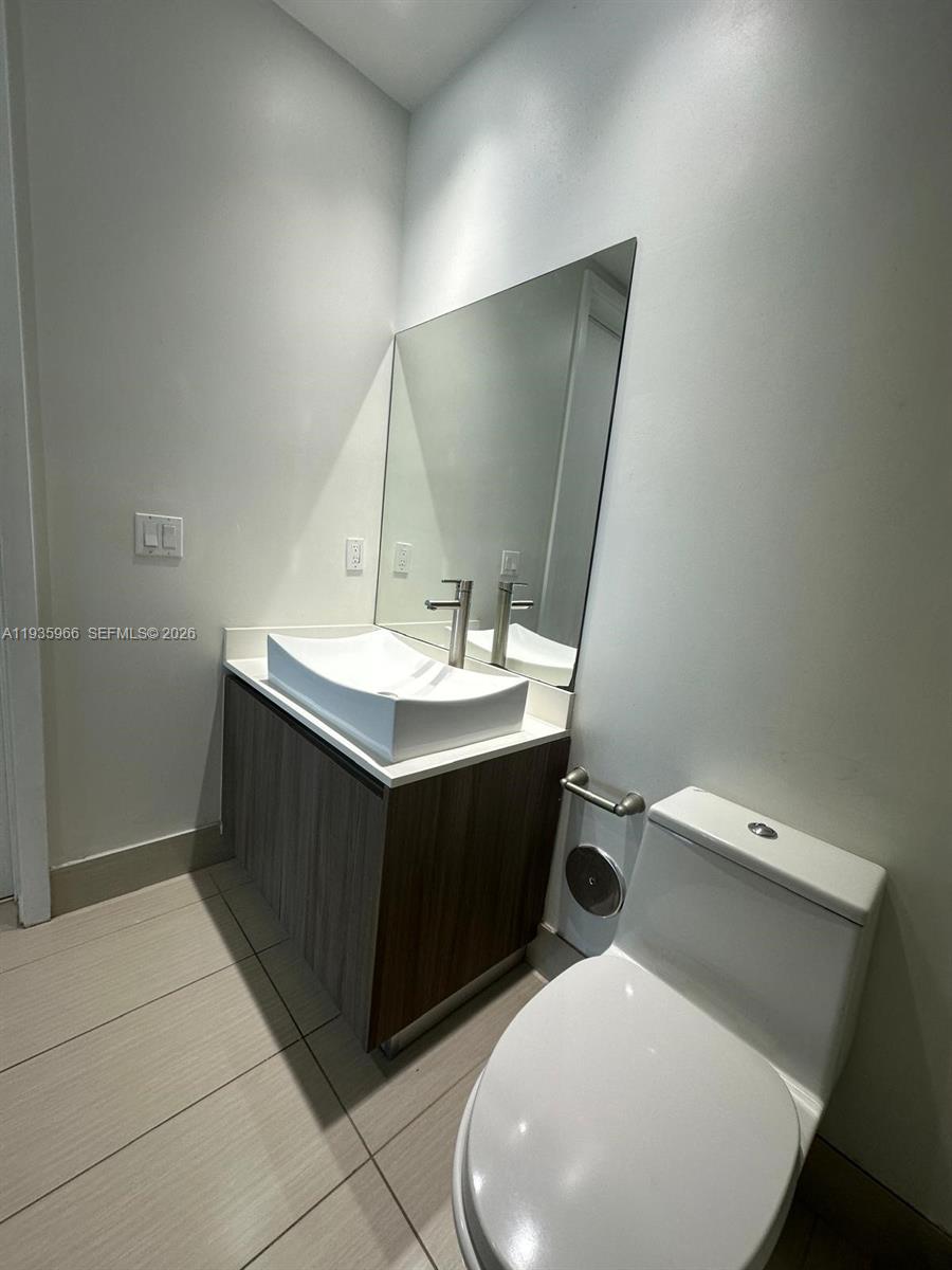 201 Southwest 17th Road, Unit 803 Miami, FL 33129 - Photo 9 of 22 a bathroom with a sink vanity and toilet