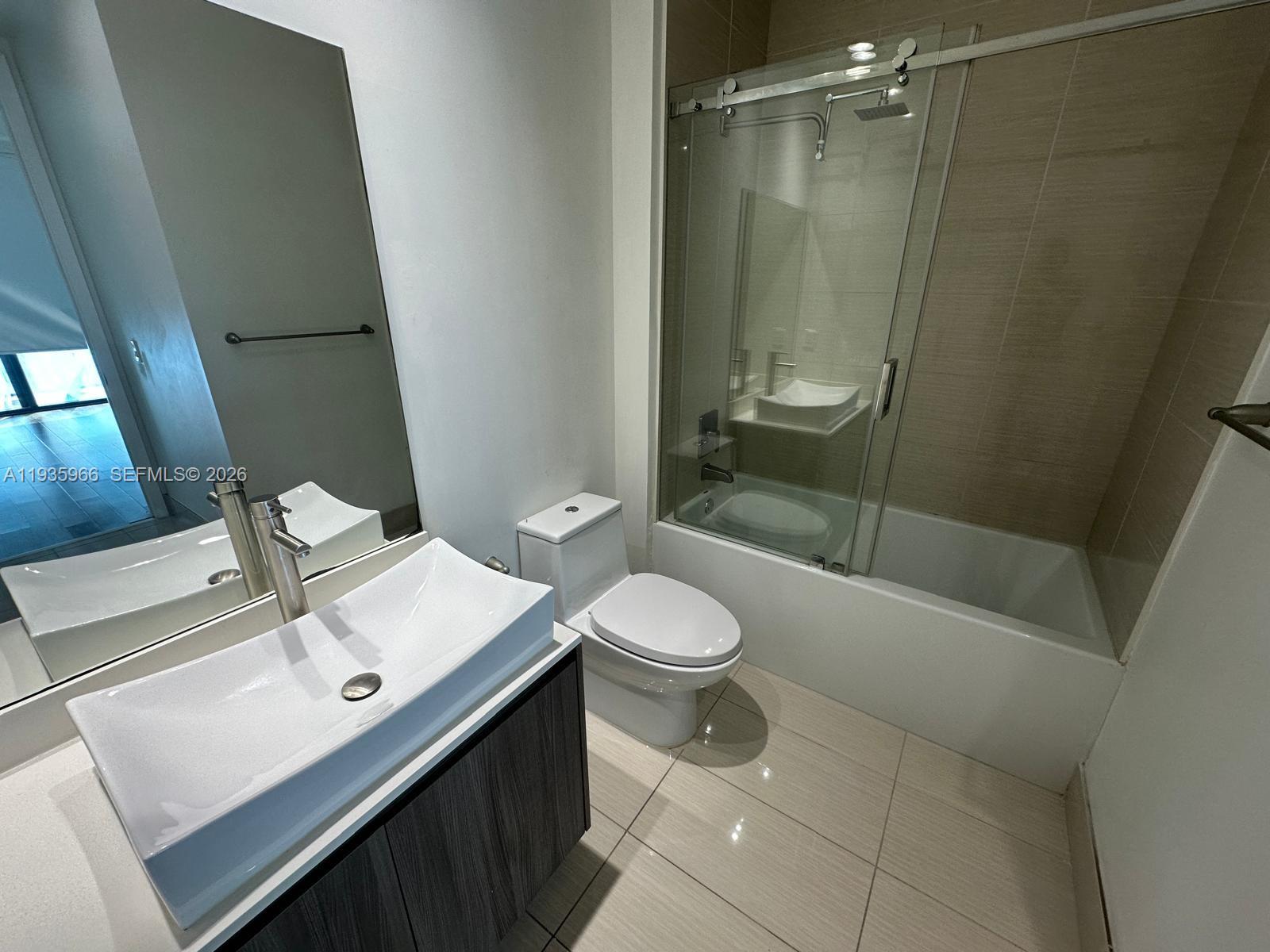 201 Southwest 17th Road, Unit 803 Miami, FL 33129 - Photo 10 of 22 a bathroom with a sink a toilet and shower