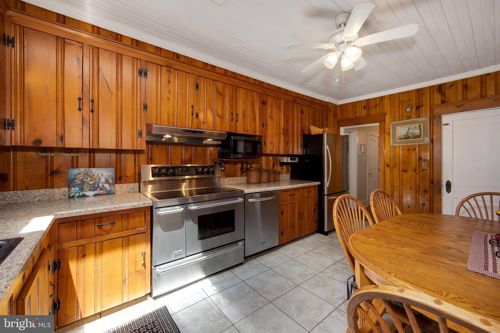 106 4 Mile Road Pemberton, NJ 08068 - Photo 12 of 42 a kitchen with stainless steel appliances granite countertop a stove a sink and a microwave