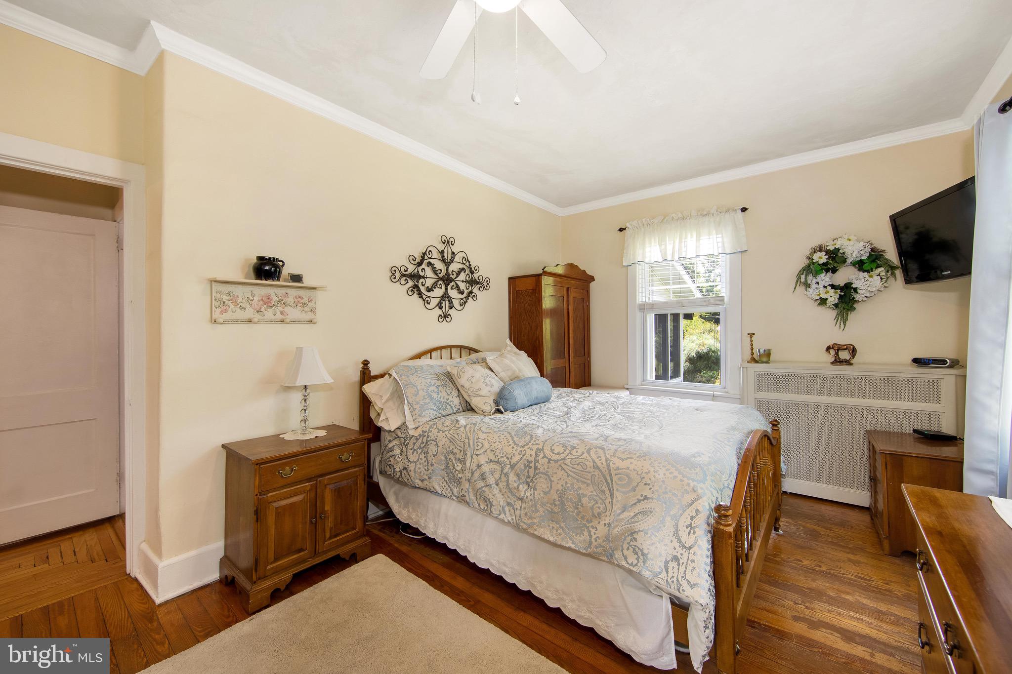 106 4 Mile Road Pemberton, NJ 08068 - Photo 18 of 42 a bedroom with a bed and a flat tv screen on dresser
