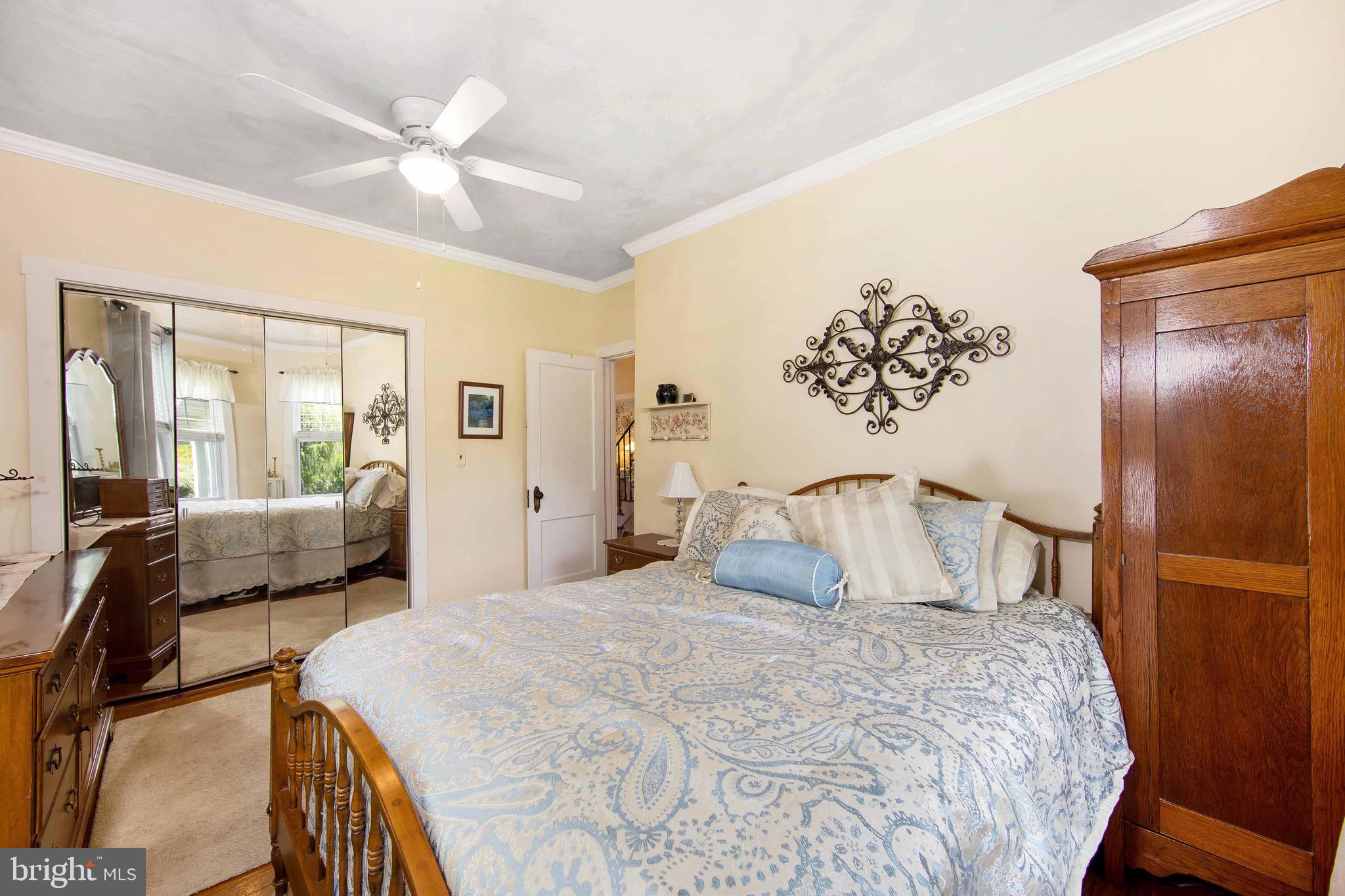 106 4 Mile Road Pemberton, NJ 08068 - Photo 19 of 42 a bedroom with a large bed and a chandelier