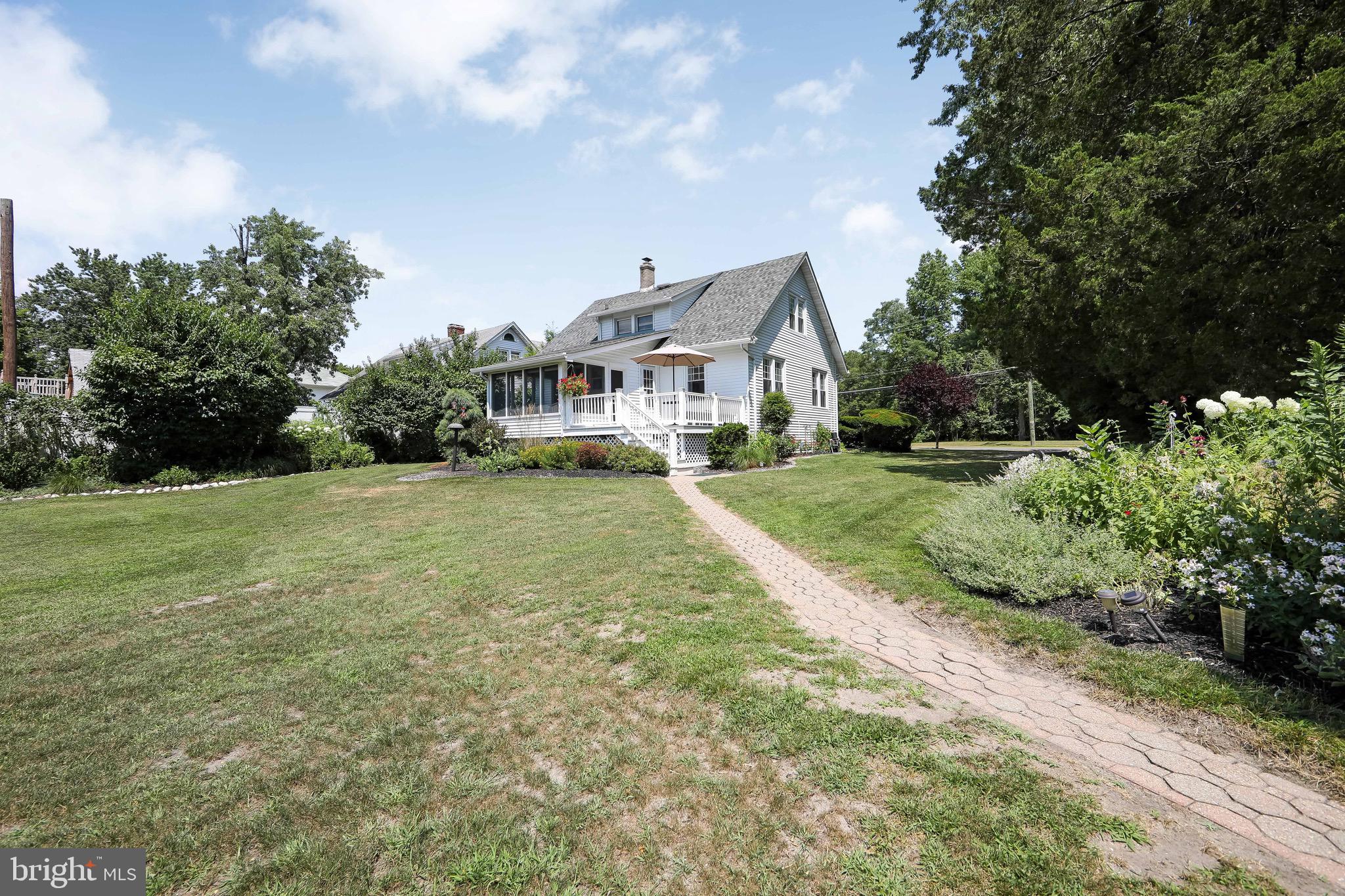 106 4 Mile Road Pemberton, NJ 08068 - Photo 30 of 42 a front view of a house with a yard and trees