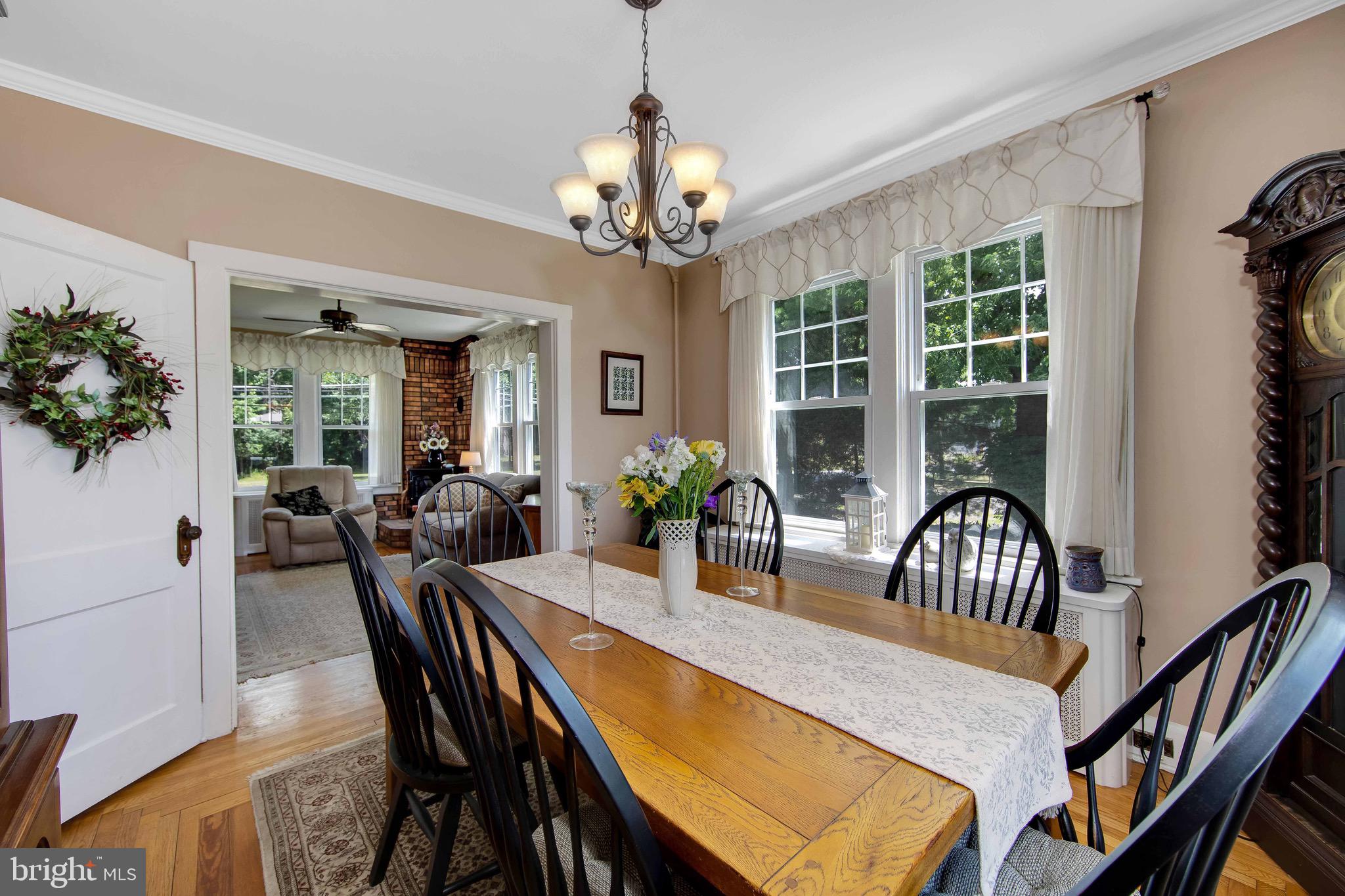 106 4 Mile Road Pemberton, NJ 08068 - Photo 9 of 42 a view of a dining room and livingroom with furniture wooden floor a chandelier and a rug