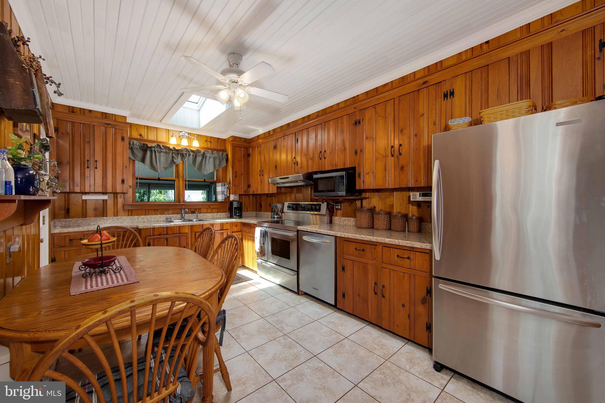 106 4 Mile Road Pemberton, NJ 08068 - Photo 10 of 42 a kitchen with stainless steel appliances a refrigerator a stove a sink dishwasher and a refrigerator with wooden floor