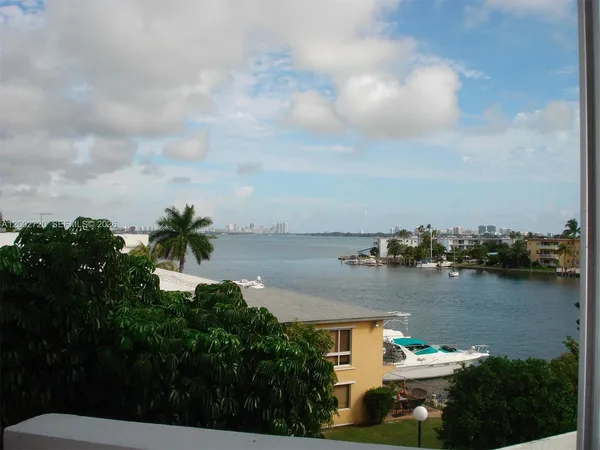 a view of a lake with houses in the back
