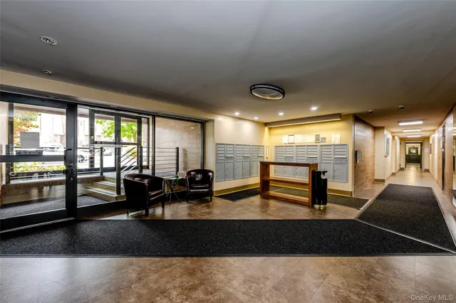 a living room with furniture and large windows