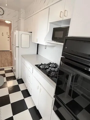 a kitchen with a stove and a refrigerator