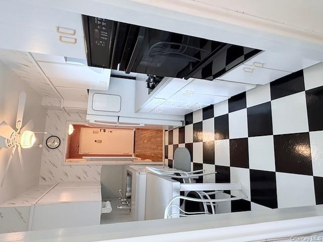 210-15 23rd Avenue, Unit 4E Queens, NY 11360 - Photo 7 of 8 a black and white checkered floor