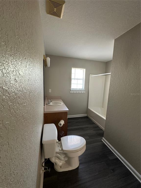 17236 3rd Street Montverde, FL 34756 - Photo 18 of 29 a bathroom with a toilet a sink and mirror