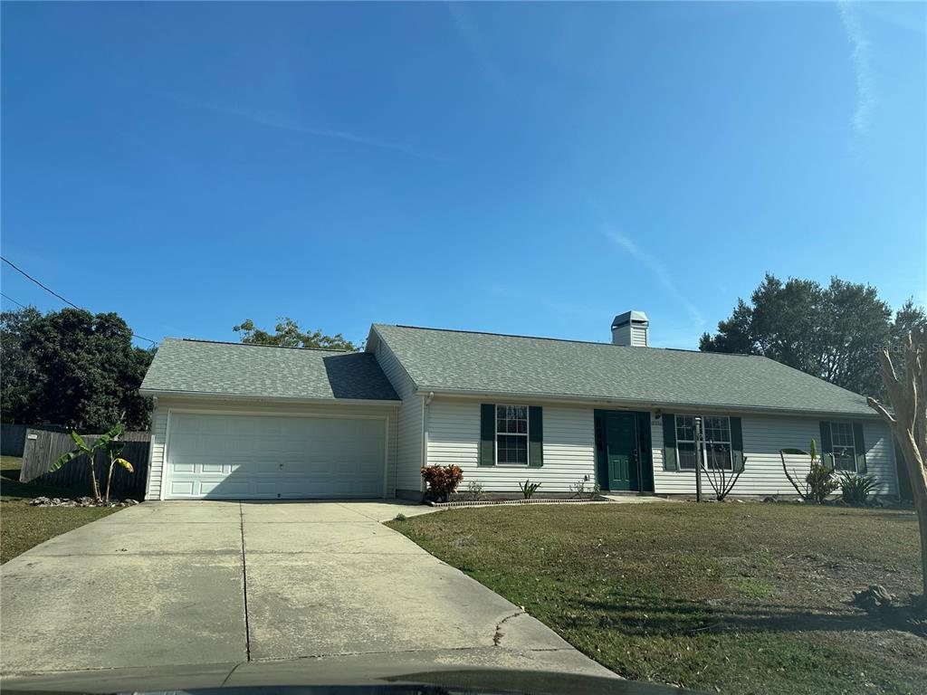 17236 3rd Street Montverde, FL 34756 - Photo 28 of 29 a front view of a house with a yard and garage