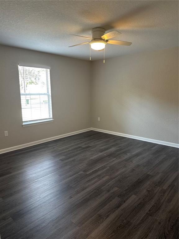 17236 3rd Street Montverde, FL 34756 - Photo 9 of 29 an empty room with wooden floor and windows