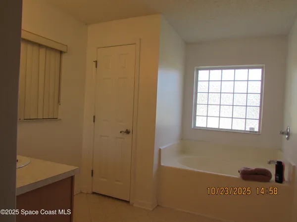 a bathroom with a window and a shower