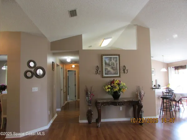 a kitchen with a table chairs stove and refrigerator