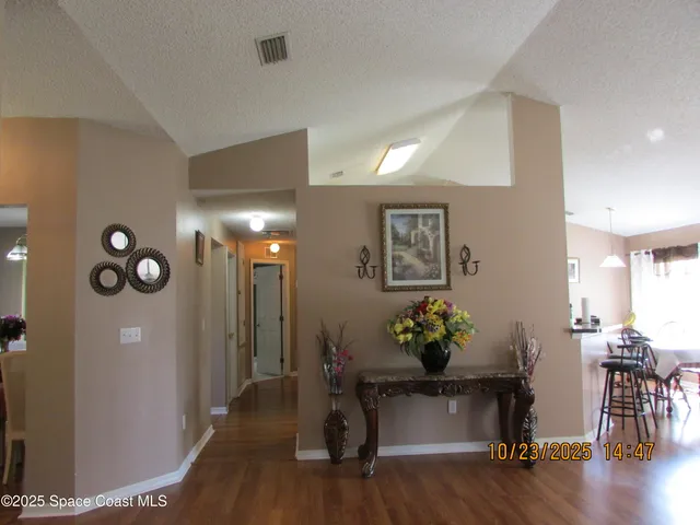 a kitchen with a table chairs stove and refrigerator