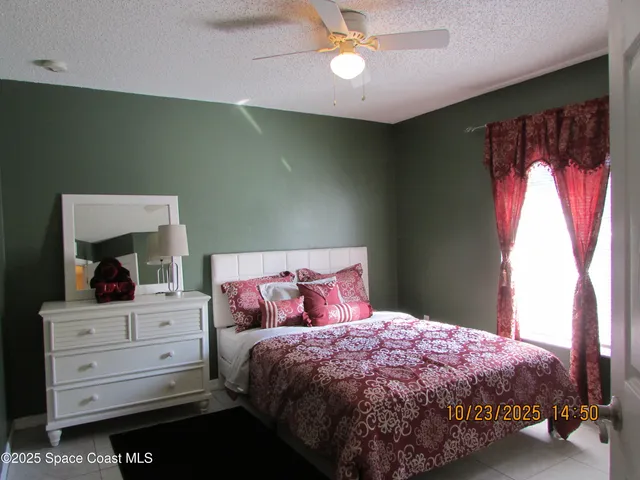 a bedroom with a bed and a lamp