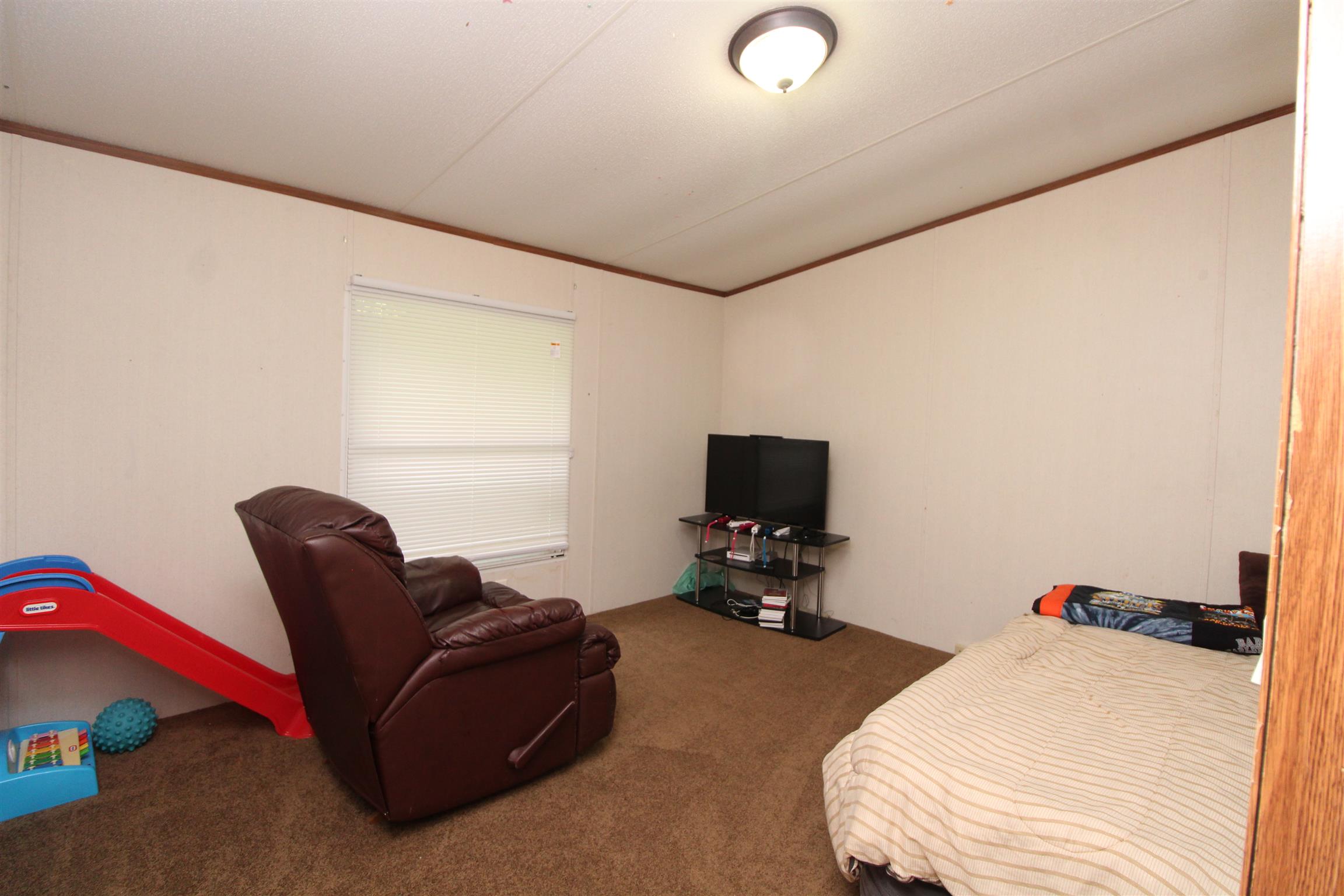 183 Henry Road Goodlettsville, TN 37072 - Photo 3 of 12 a bedroom with a bed and a chair