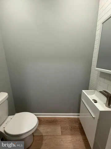 a white toilet sitting next to a white sink