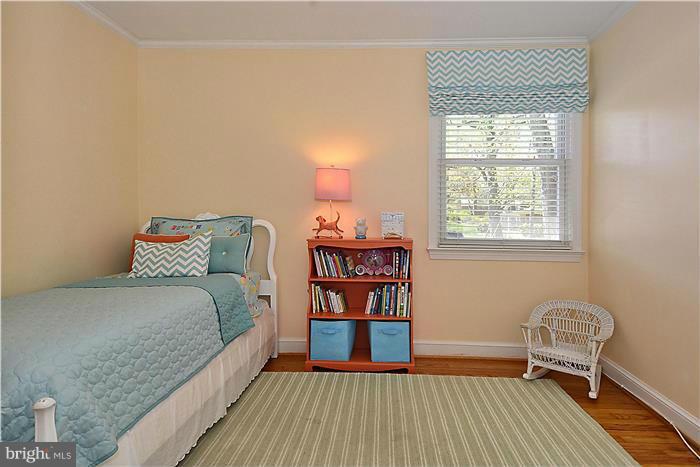 1003 Strout Street Silver Spring, MD 20901 - Photo 14 of 28 a bedroom with a bed and wooden floor