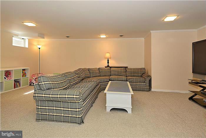 1003 Strout Street Silver Spring, MD 20901 - Photo 21 of 28 a bedroom with a bed and a flat screen tv