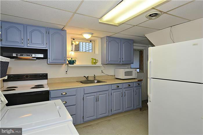 1003 Strout Street Silver Spring, MD 20901 - Photo 23 of 28 a kitchen with a white cabinets and white appliances