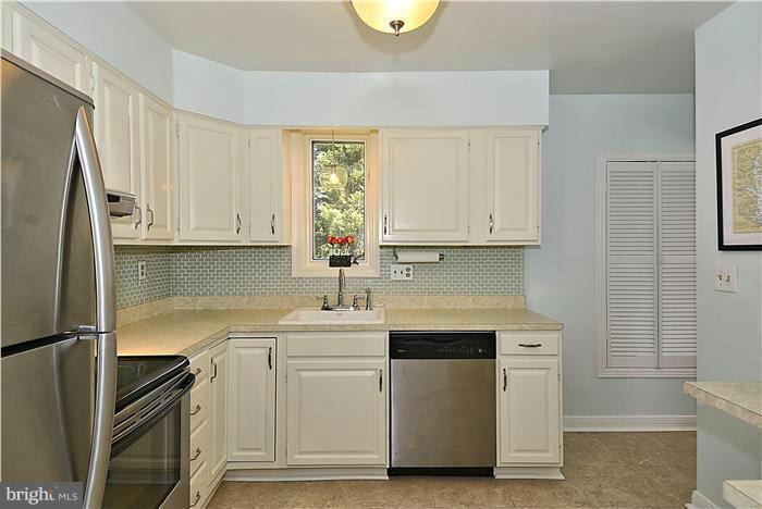 1003 Strout Street Silver Spring, MD 20901 - Photo 8 of 28 a kitchen with a sink cabinets stainless steel appliances and a window