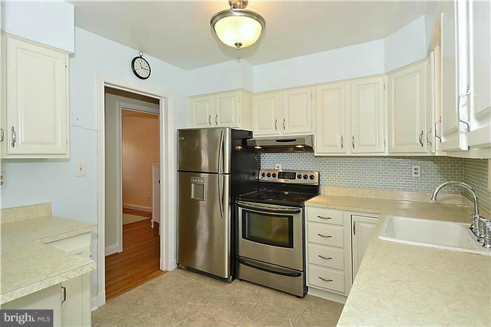 1003 Strout Street Silver Spring, MD 20901 - Photo 9 of 28 a kitchen with stainless steel appliances granite countertop a refrigerator sink and stove