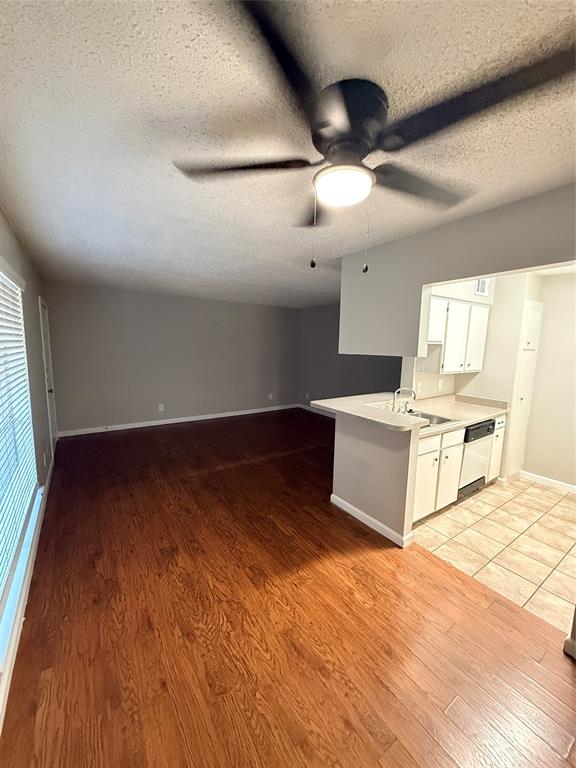 1000 West Spring Valley Road Richardson, TX 75080 - Photo 1 of 7 a view of a kitchen with wooden floor and a ceiling fan