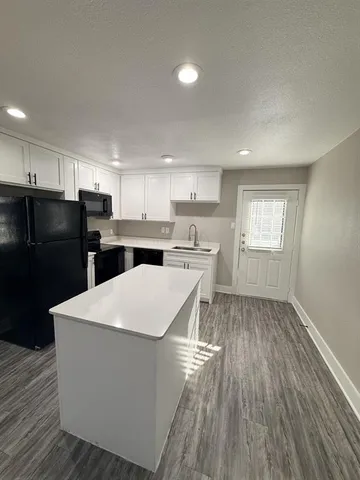 a kitchen with stainless steel appliances a refrigerator sink and cabinets