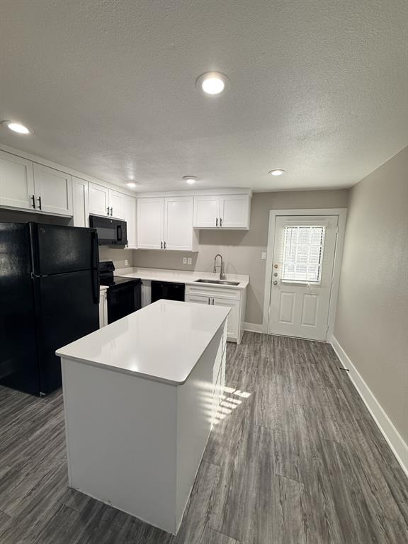 1000 West Spring Valley Road Richardson, TX 75080 - Photo 6 of 7 a kitchen with stainless steel appliances a refrigerator sink and cabinets