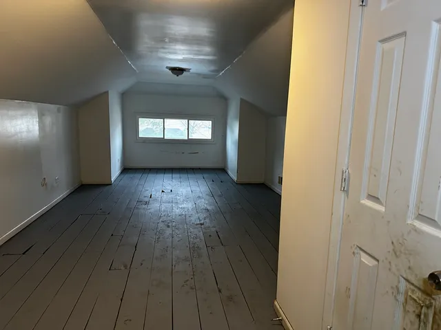 a view of wooden floor and windows in a room
