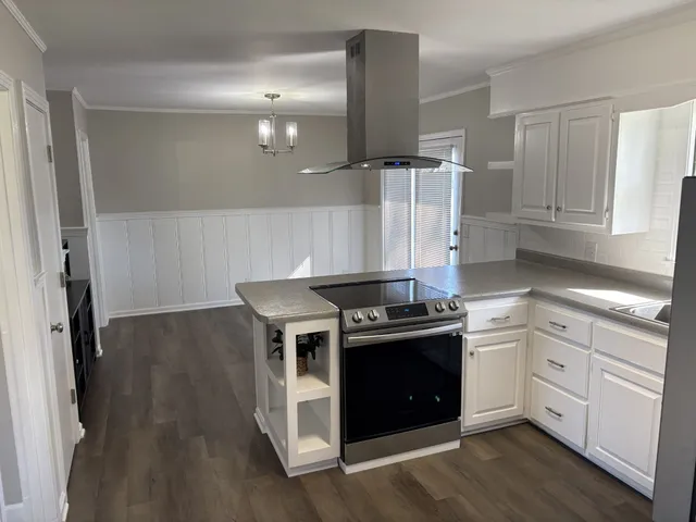 a kitchen with stainless steel appliances granite countertop a refrigerator sink and white cabinets