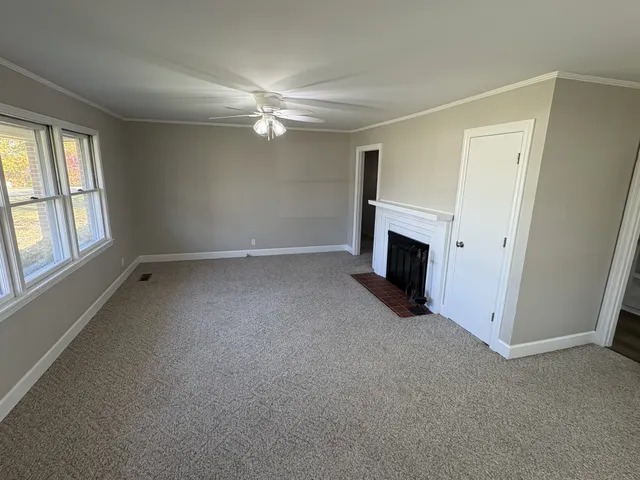 a view of empty room with a fireplace