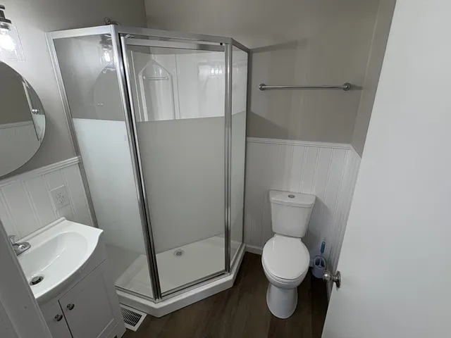 a bathroom with a sink a mirror and shower