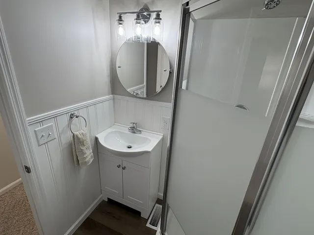 a bathroom with a glass door shower and toilet
