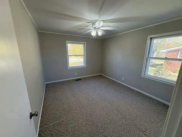 a view of an empty room with a window