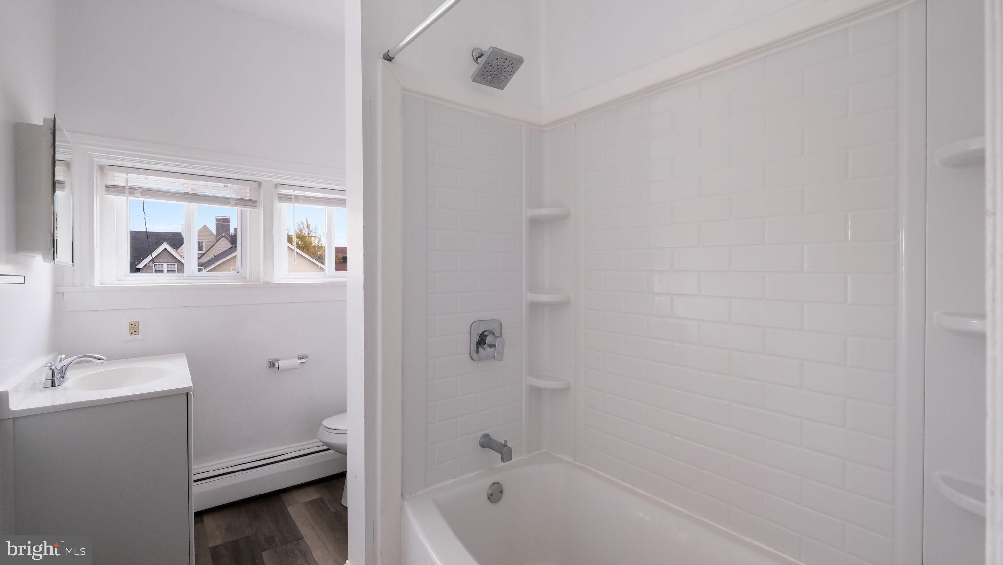 4 West State Street, Unit B Media, PA 19063 - Photo 12 of 14 a bathroom with a tub sink and mirror