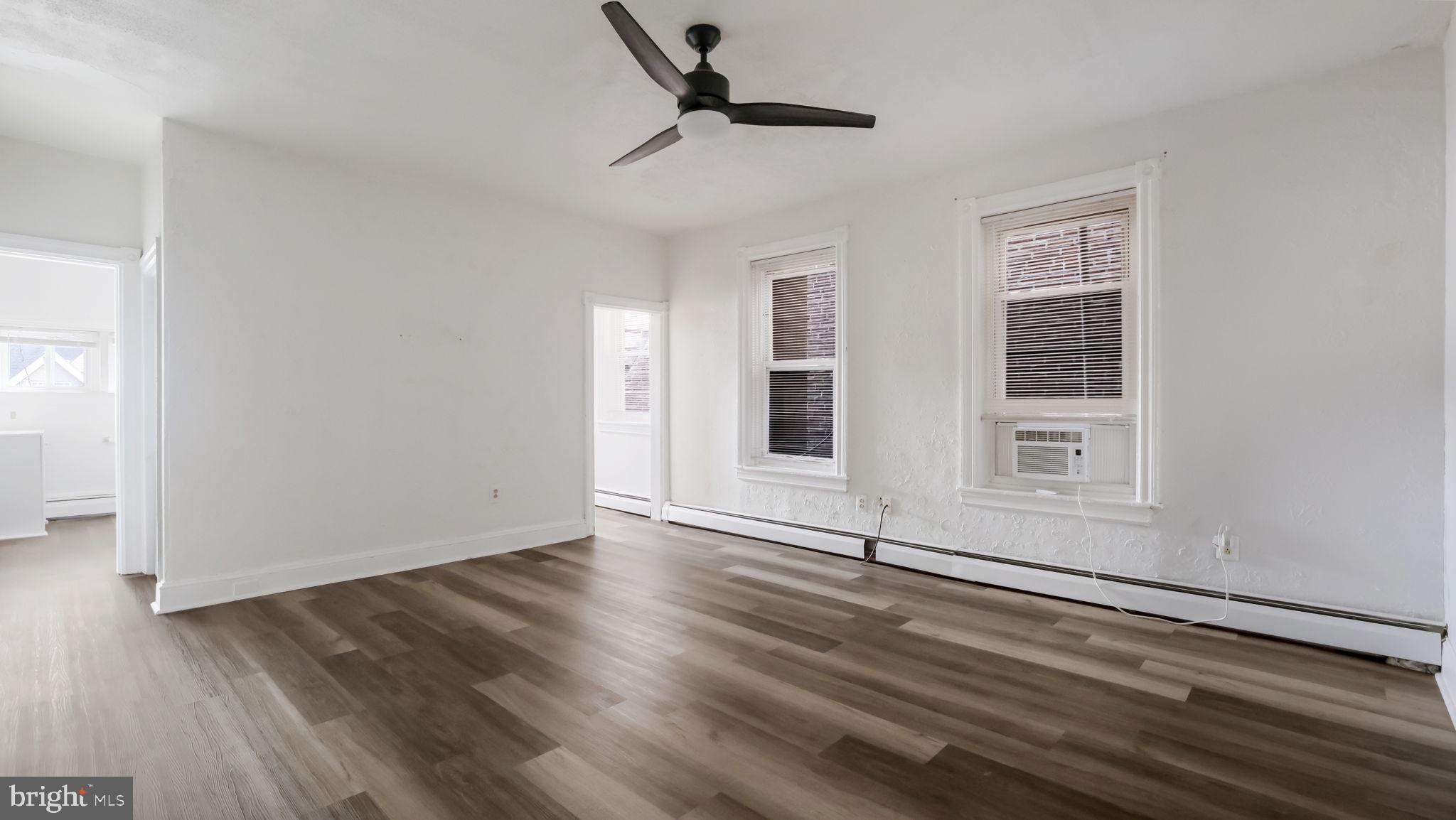 4 West State Street, Unit B Media, PA 19063 - Photo 7 of 14 a view of an empty room with wooden floor and a window