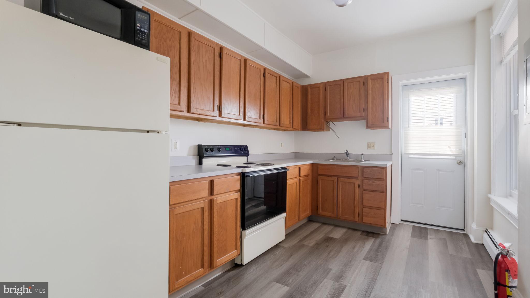 4 West State Street, Unit B Media, PA 19063 - Photo 8 of 14 a kitchen with stainless steel appliances granite countertop a refrigerator sink and cabinets