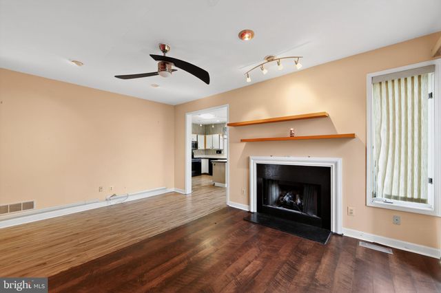 a view of a livingroom with a fireplace a fireplace and wooden floor