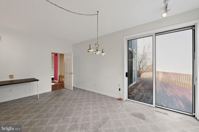 a view of a room with furniture and a chandelier