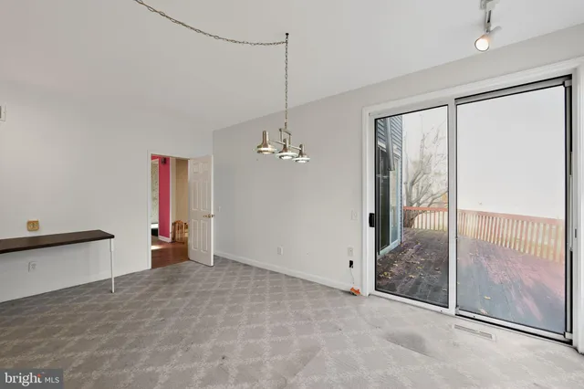 a view of a room with furniture and a chandelier